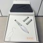 Open box of a 3DISC Heron intraoral scanner showing the handpiece and two tips neatly arranged in white packaging.